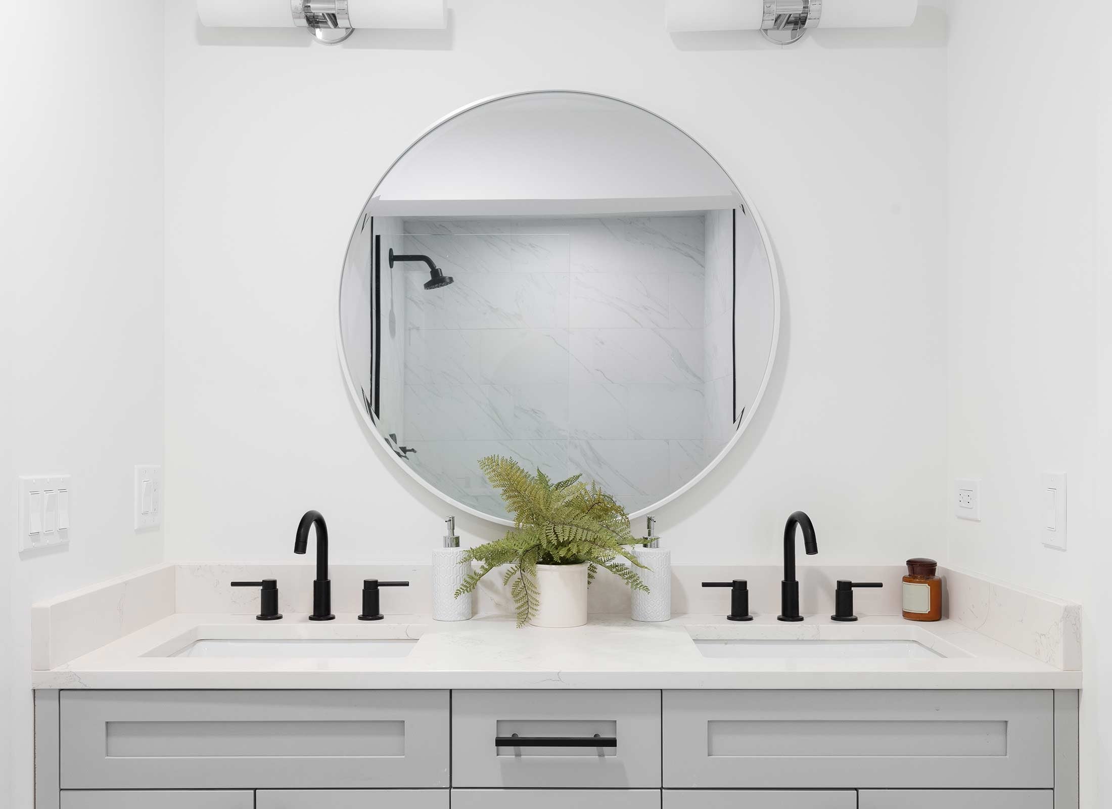 Bathroom Interior with Round Mirror and Sinks