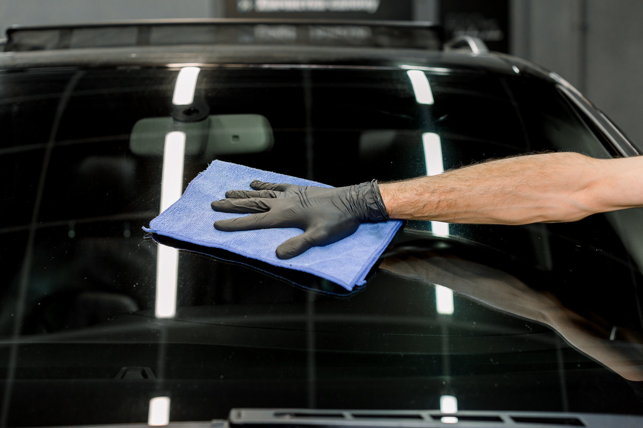 Hand Wiping a Windshield with Cloth