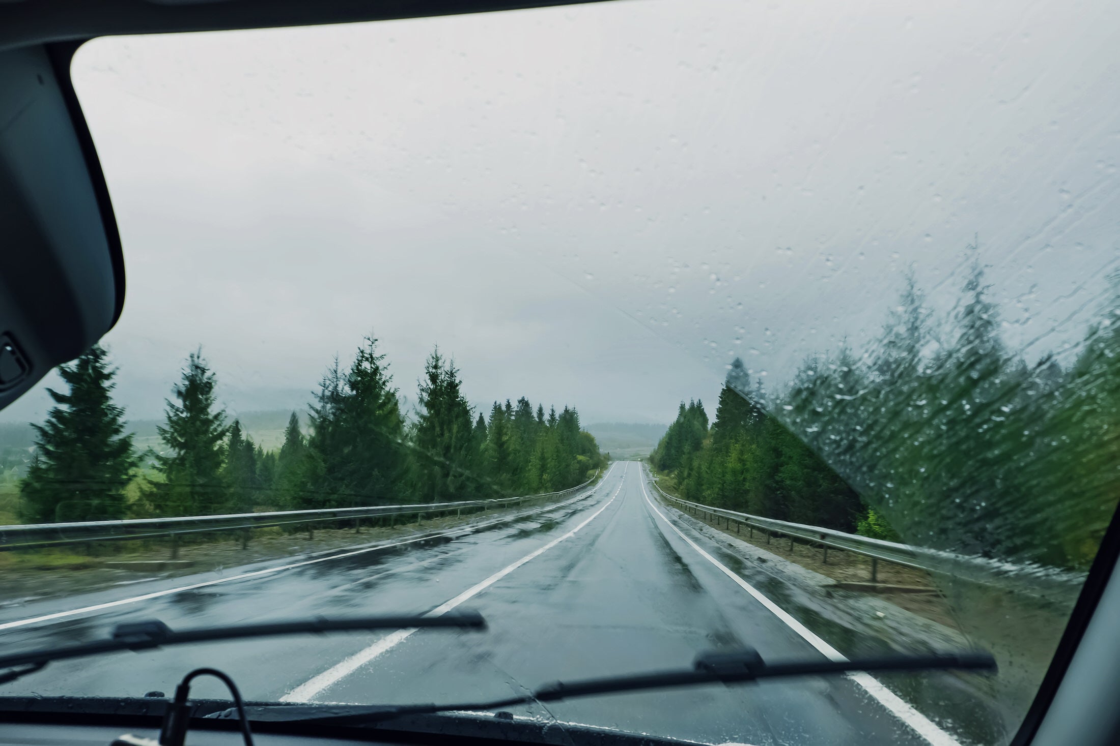 Windshield Water Repellent Shown Repelling Rain and Road Grime