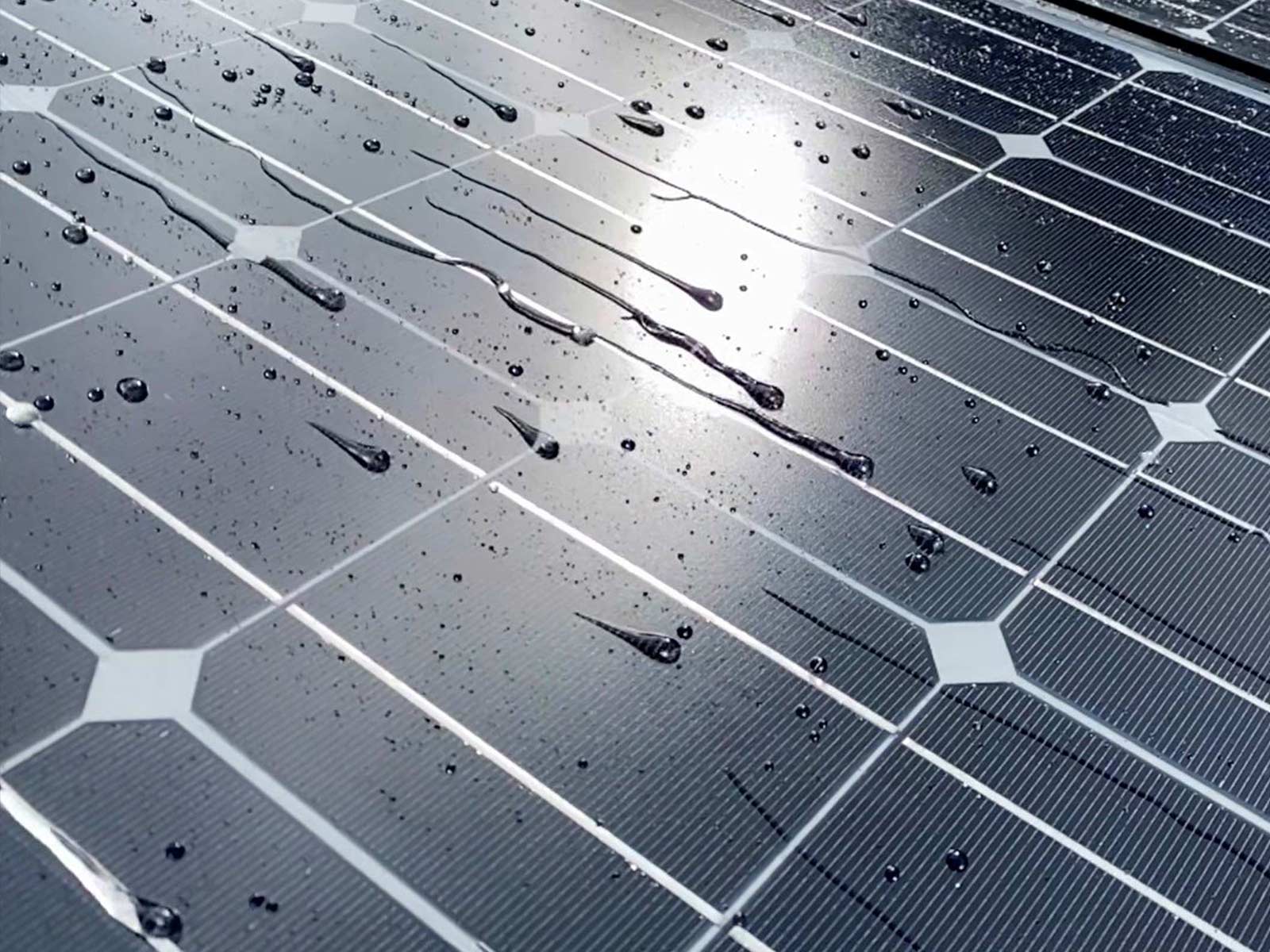 Water rolling off solar panels treated with coating
