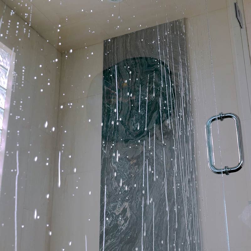 Upward Angle of Water Drops Beading Down Shower Glass Door